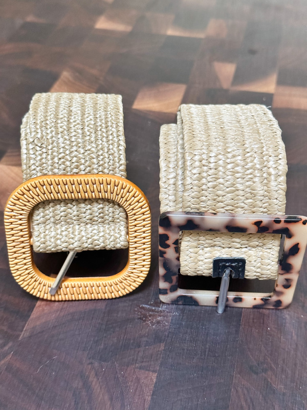 Two woven belts rolled up next to each other.