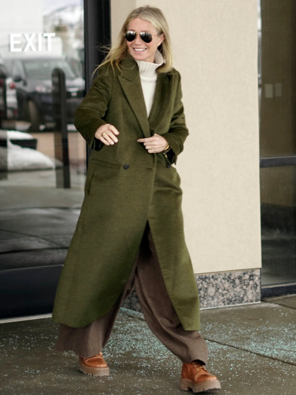 Gwyneth Paltrow in long olive coat existing court house.