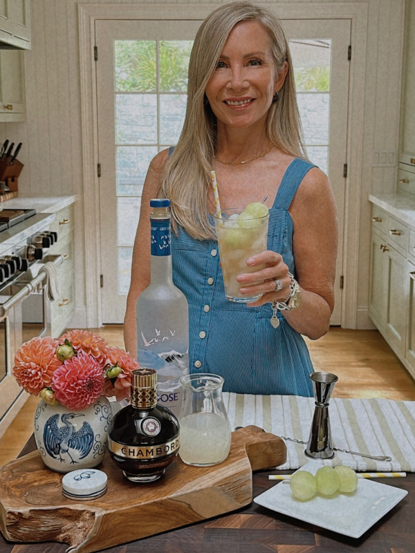 Woman holding Honey Deuce cocktail.