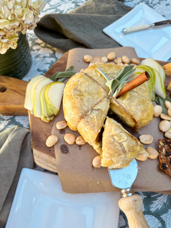 Alice Lane teak serving board covered with baked brie.