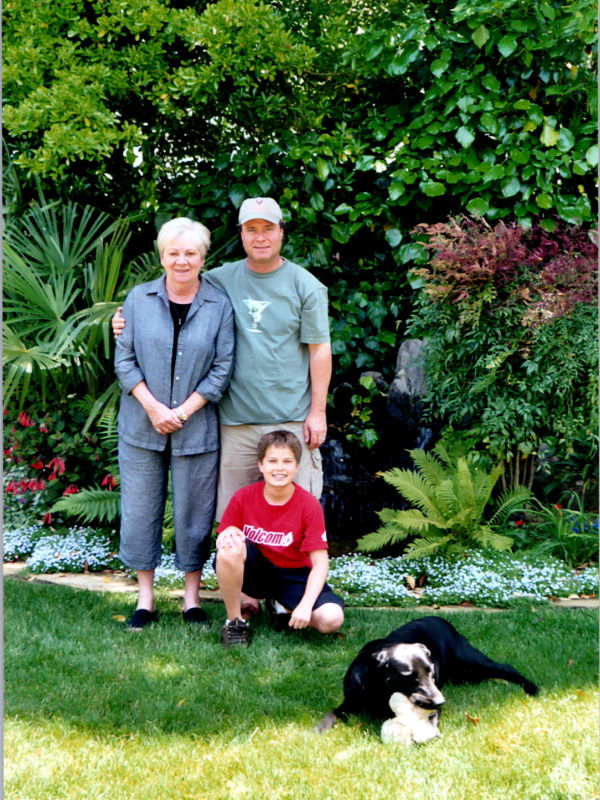 Family with dog in backyard.