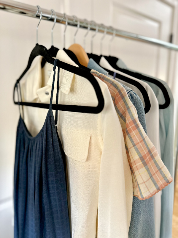 Hanging rack of dresses and jackets.