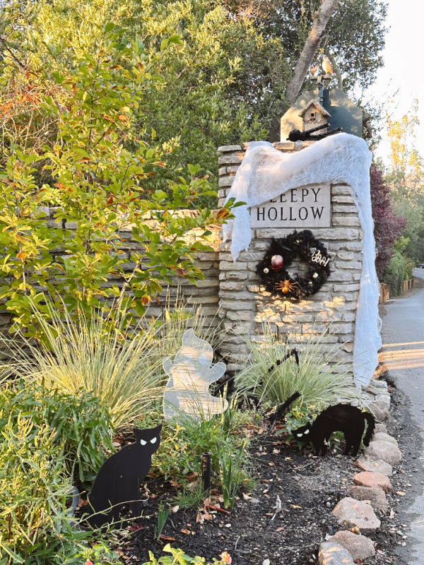 Sleepy Hollow neighborhood entrance pillar decorated for Halloween.