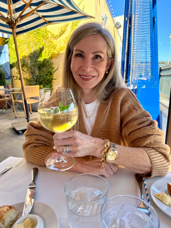Woman holding spritzer glass at Angele in Napa.