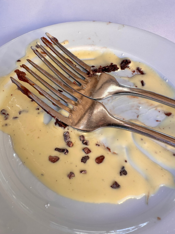 Two forks on an empty dessert plate at Angele in Napa.