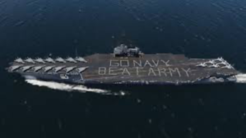Overhead shot of aircraft carrier spelling out Go Navy Beat Army.