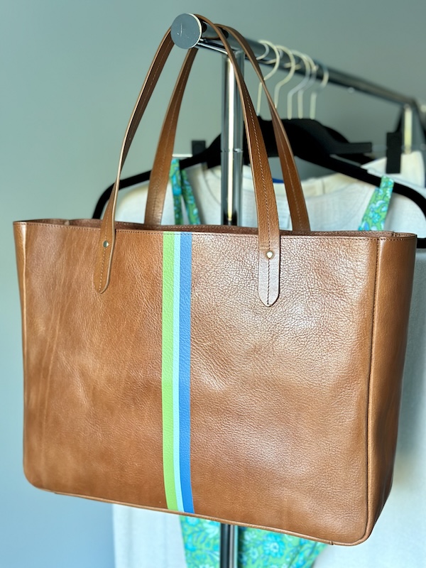 Ivy Cove East West tote on rolling rack.