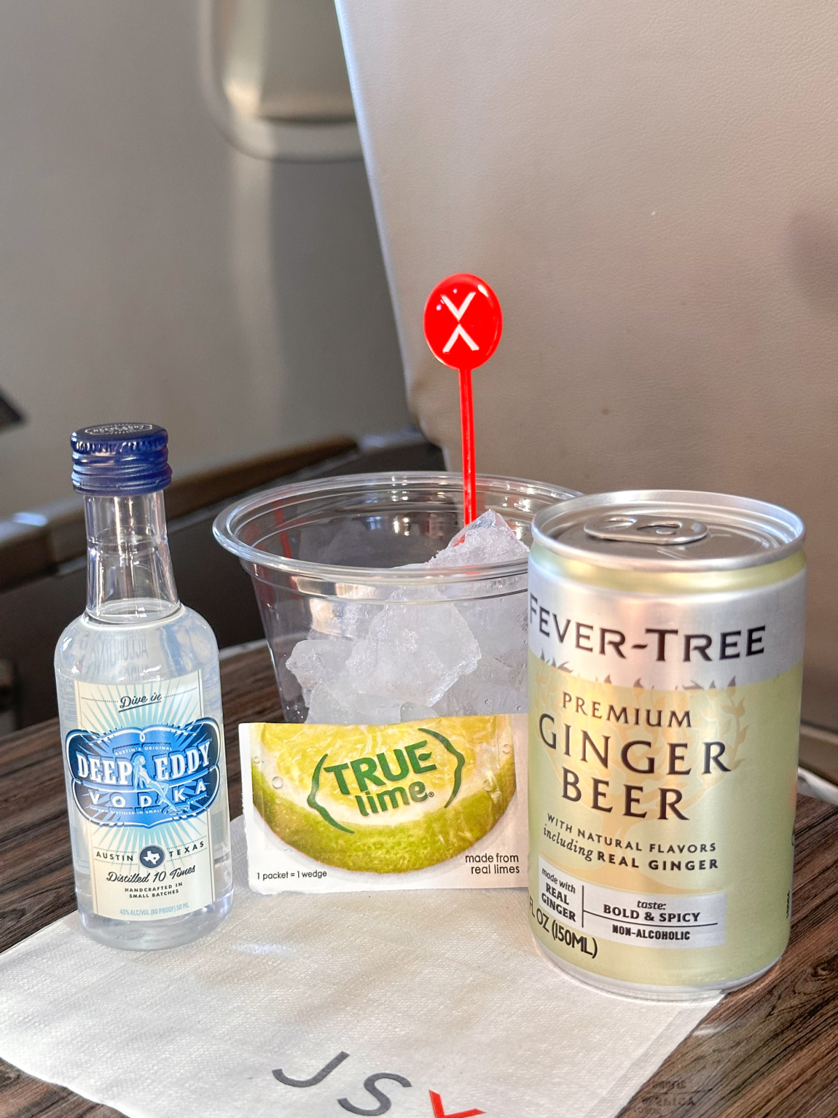 JSX airline drink on tray table.