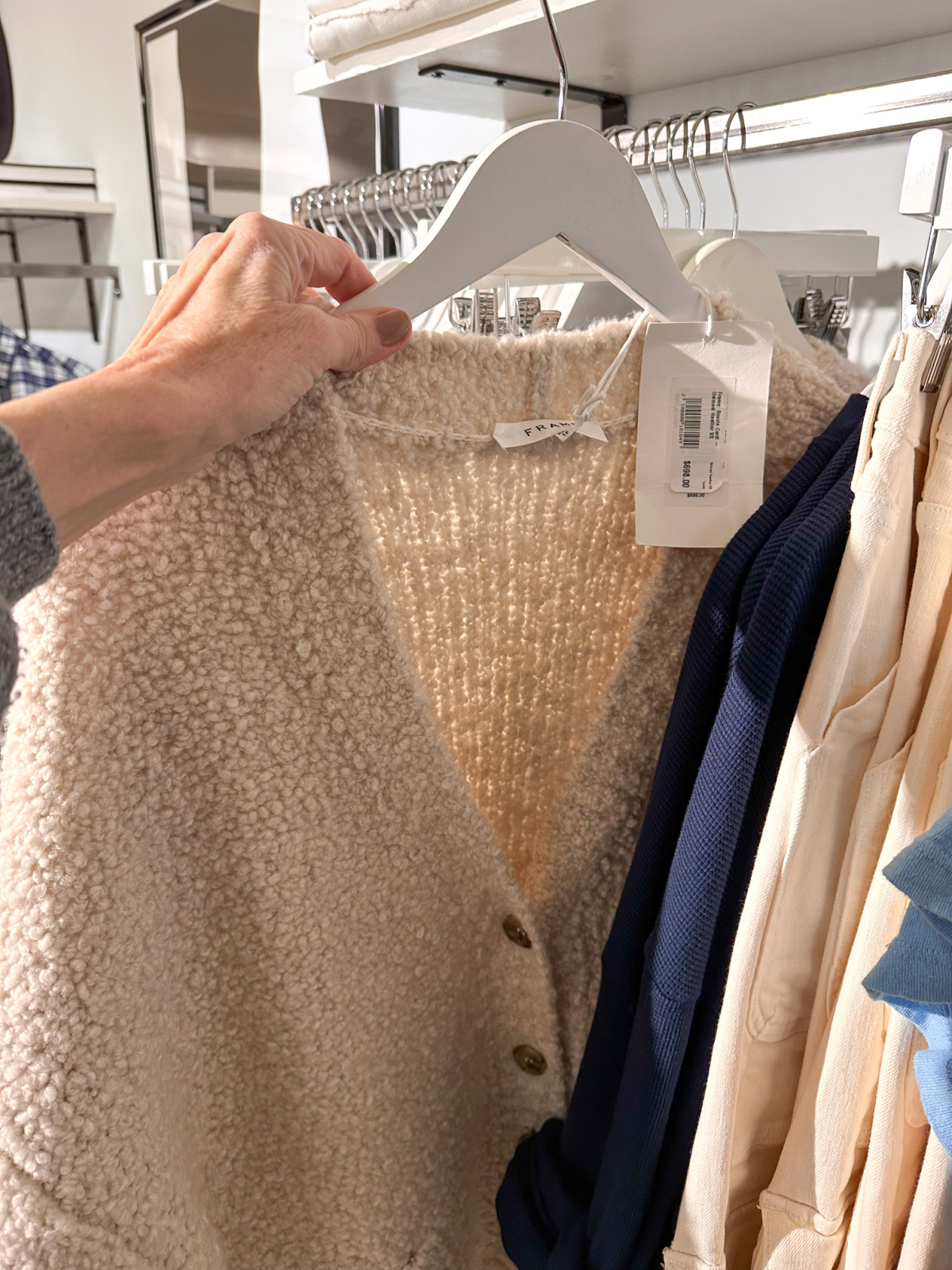 Frame boucle cardigan on rack in Wheat boutique.