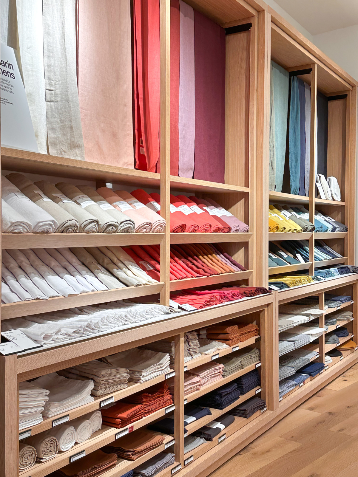 Shelves full of colorful linens at Crate & Barrel.