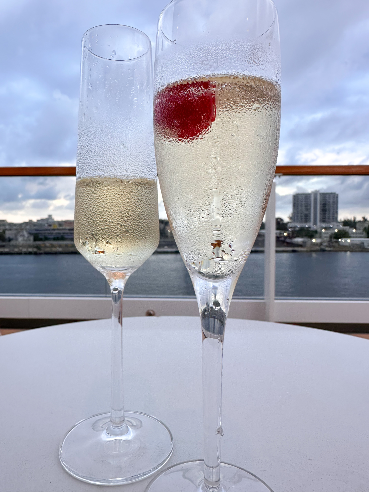 Champagne glasses on table on Observation Deck of Evrima yacht.