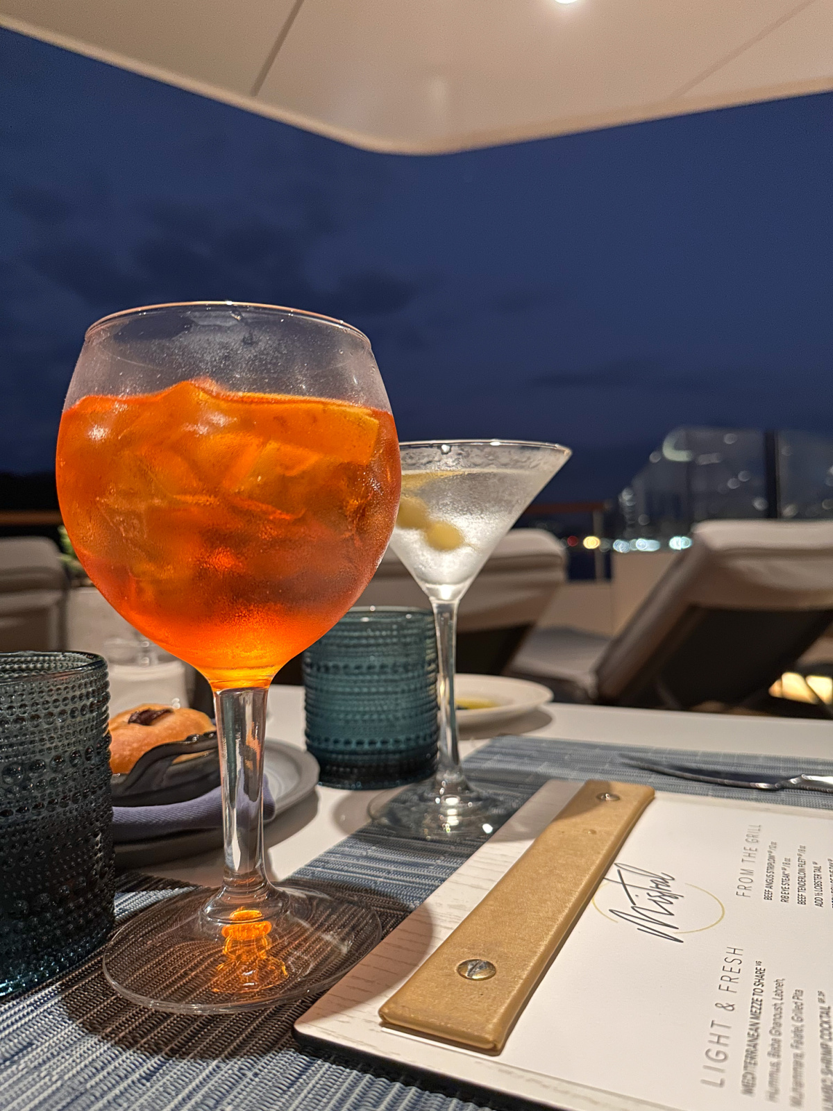 Aperol Spritz and martini on table at Mistral on the Evrima yacht.
