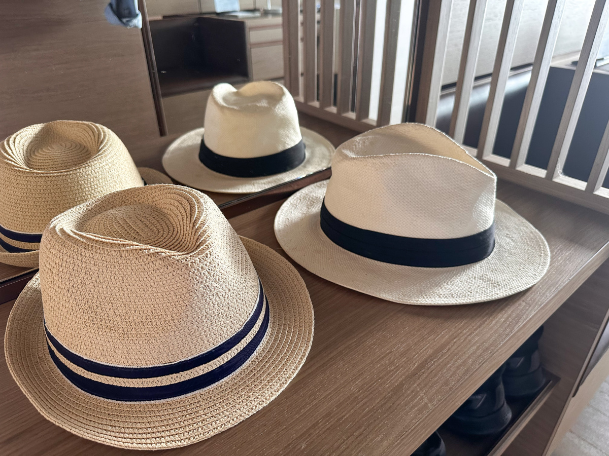 Hats on a countertop in Signature Suite on Evrima yacht.