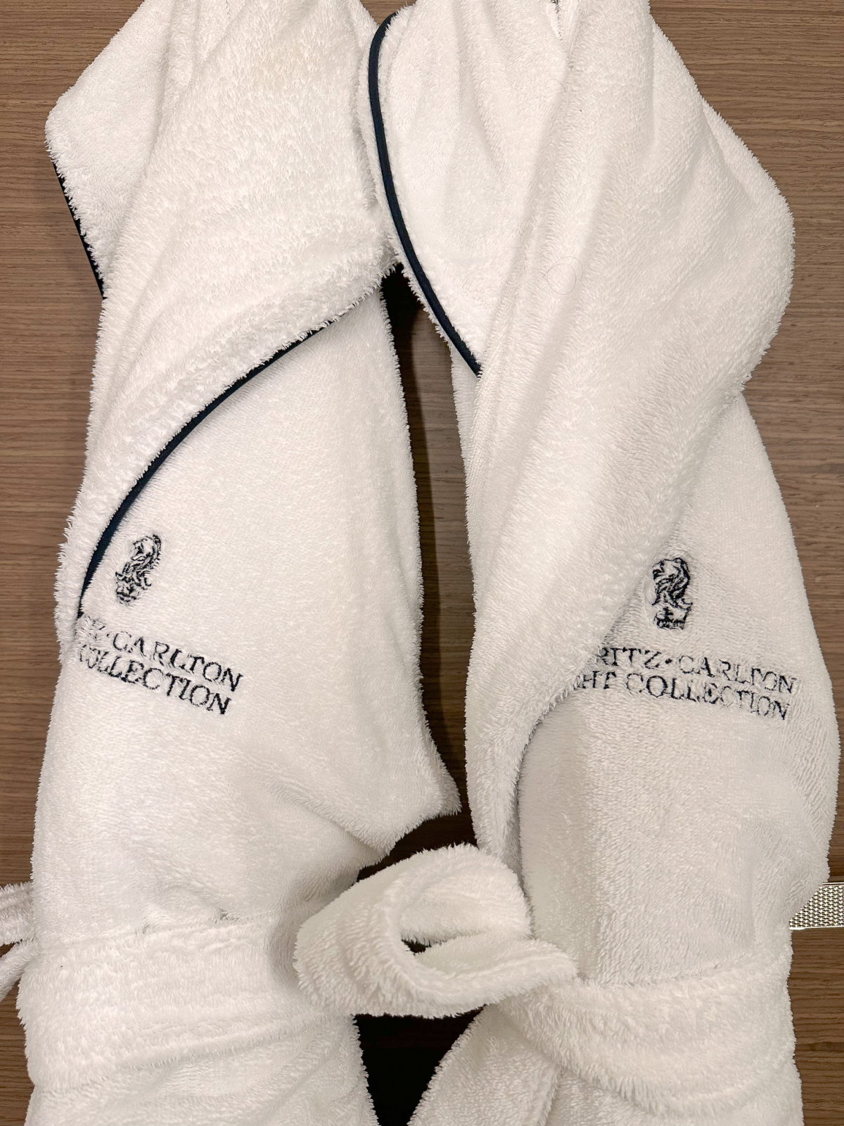 Ritz Carlton Yacht Collection bathrobes hanging on back of dor.