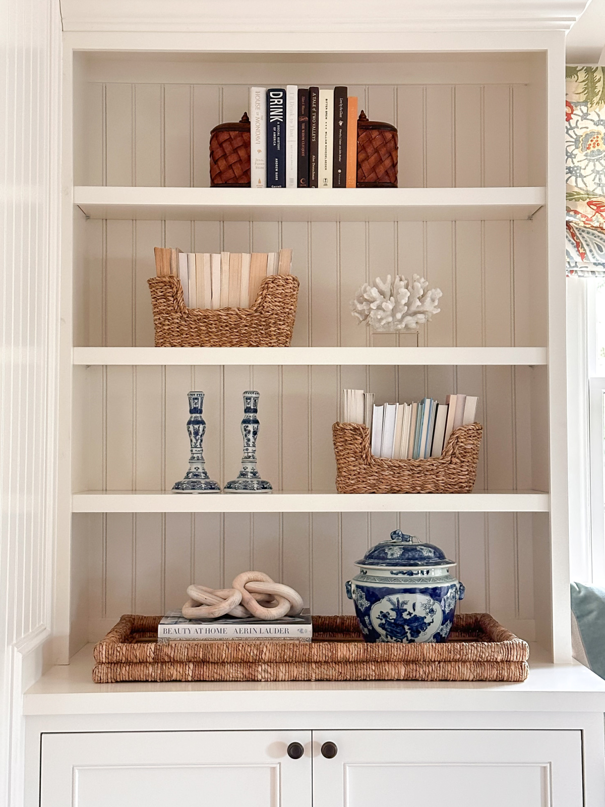 White built-in shelves styled with many things.