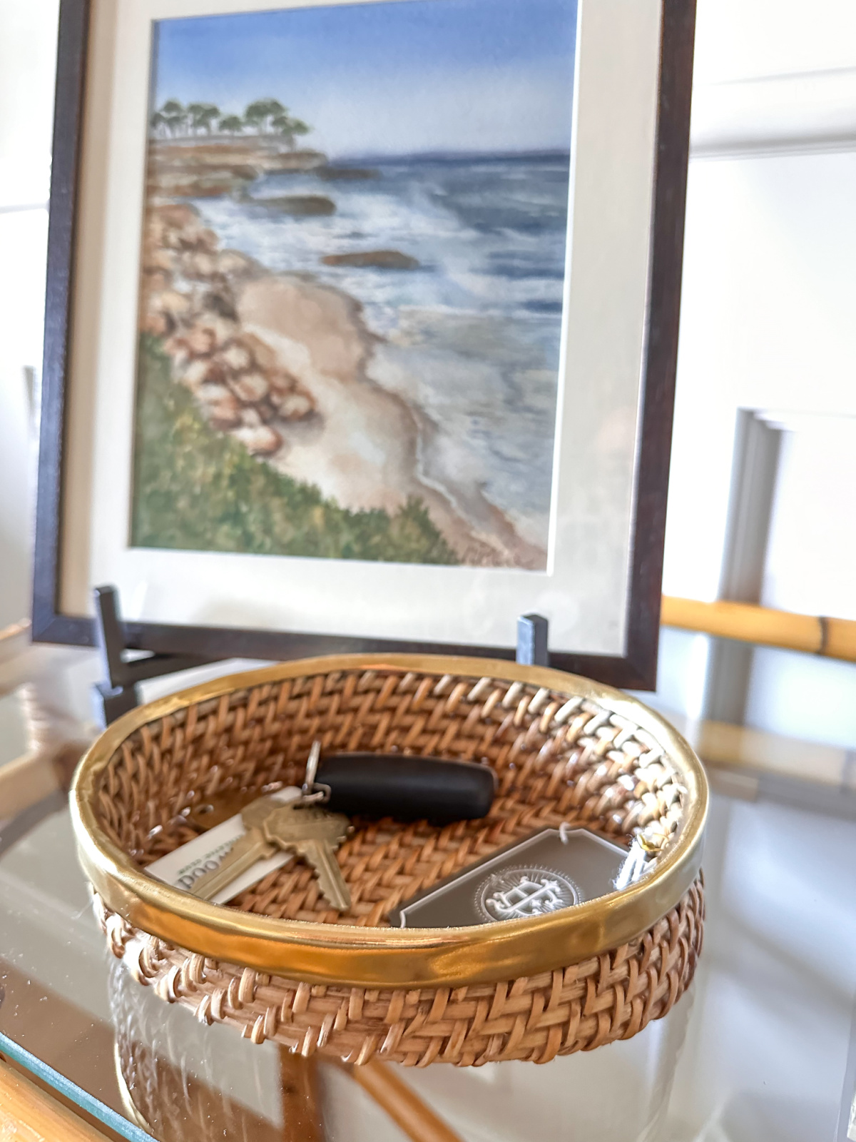 Rattan catchall tray on console table.