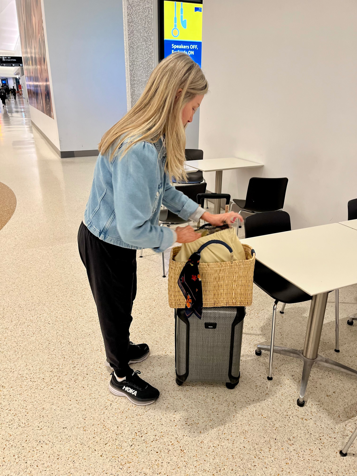 Woman checking luggage at SFO terminal.
