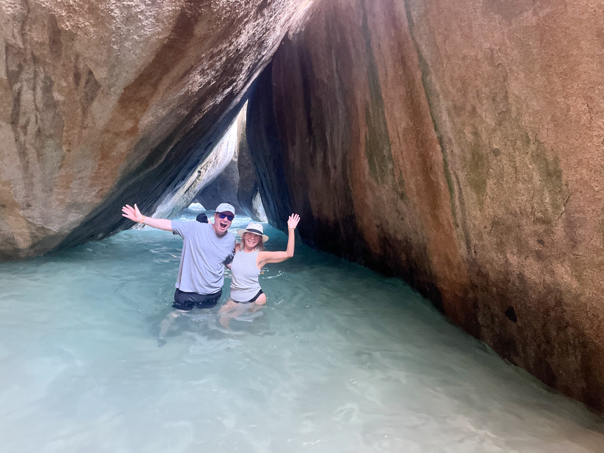 Couple standing in water under the Virgin Gorda Bath caves.