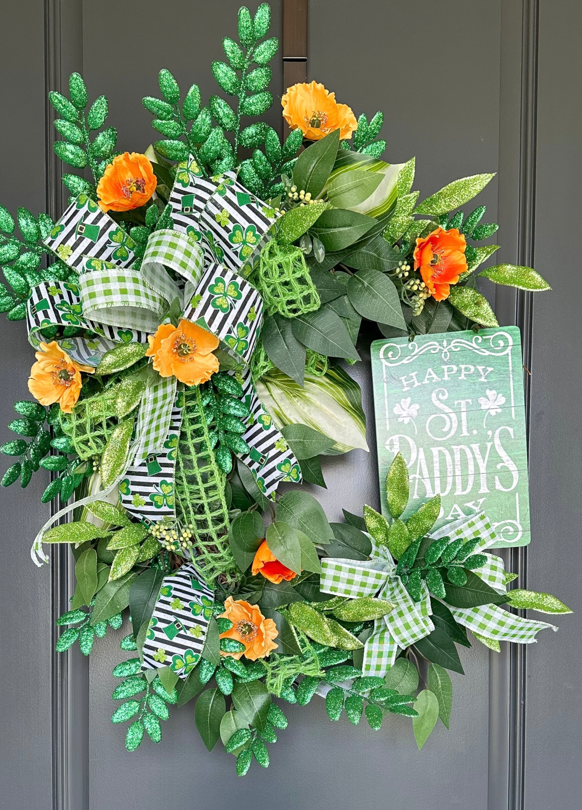 St. Patrick's Day wreath on gray front door.