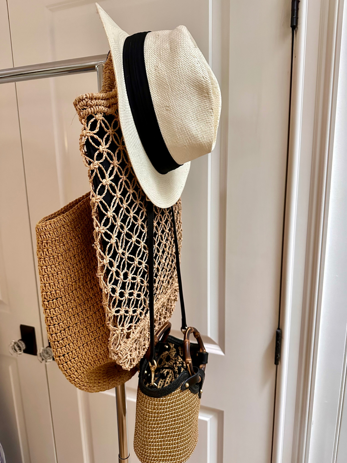 Summer bags and hat on rolling rack.