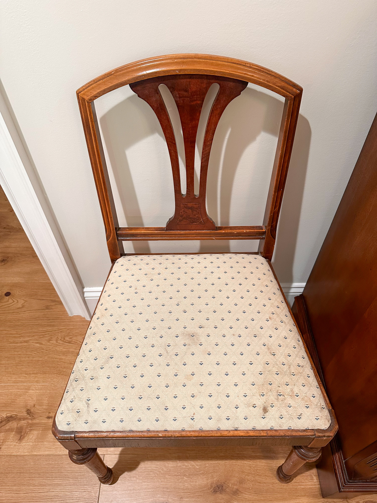 Old dining chair needing reupholstry.