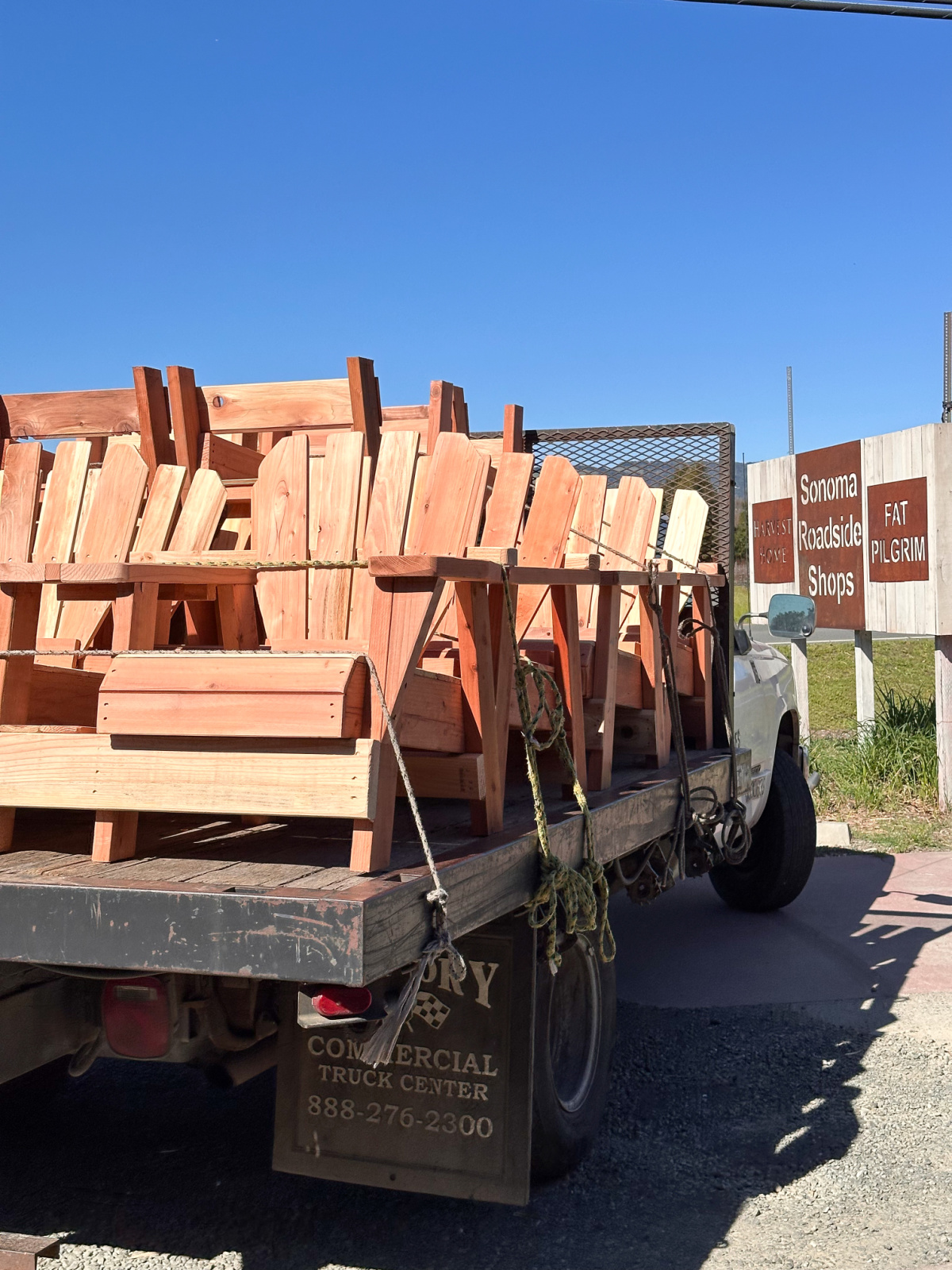 Adirondack chairs on back of flatbed truck.