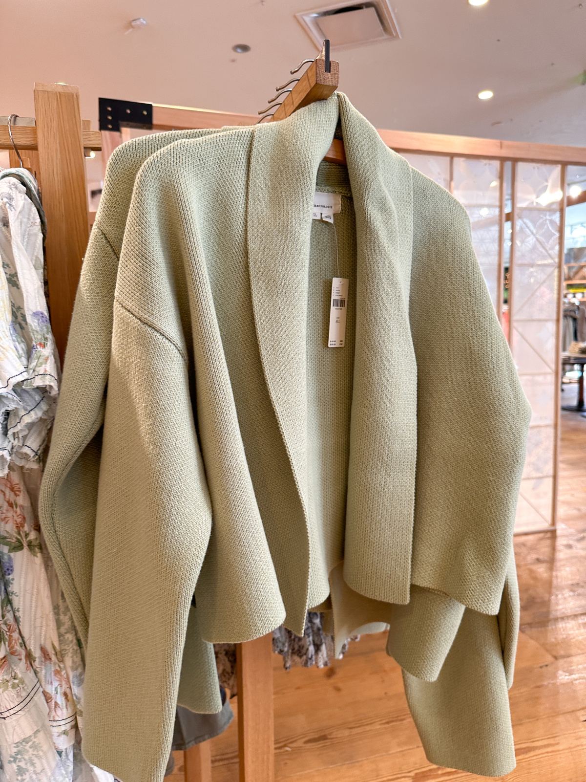 Green cardigans on rack at Anthropology.