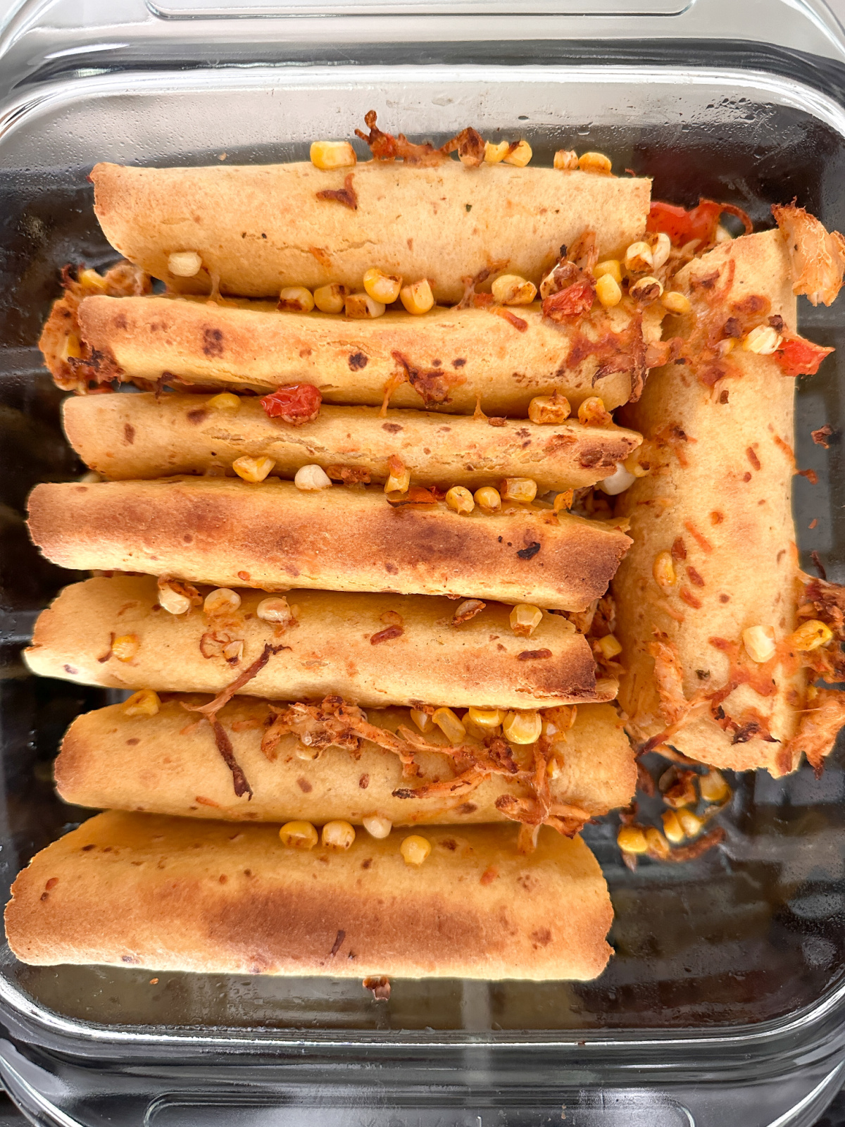Various stages of making taquitos.