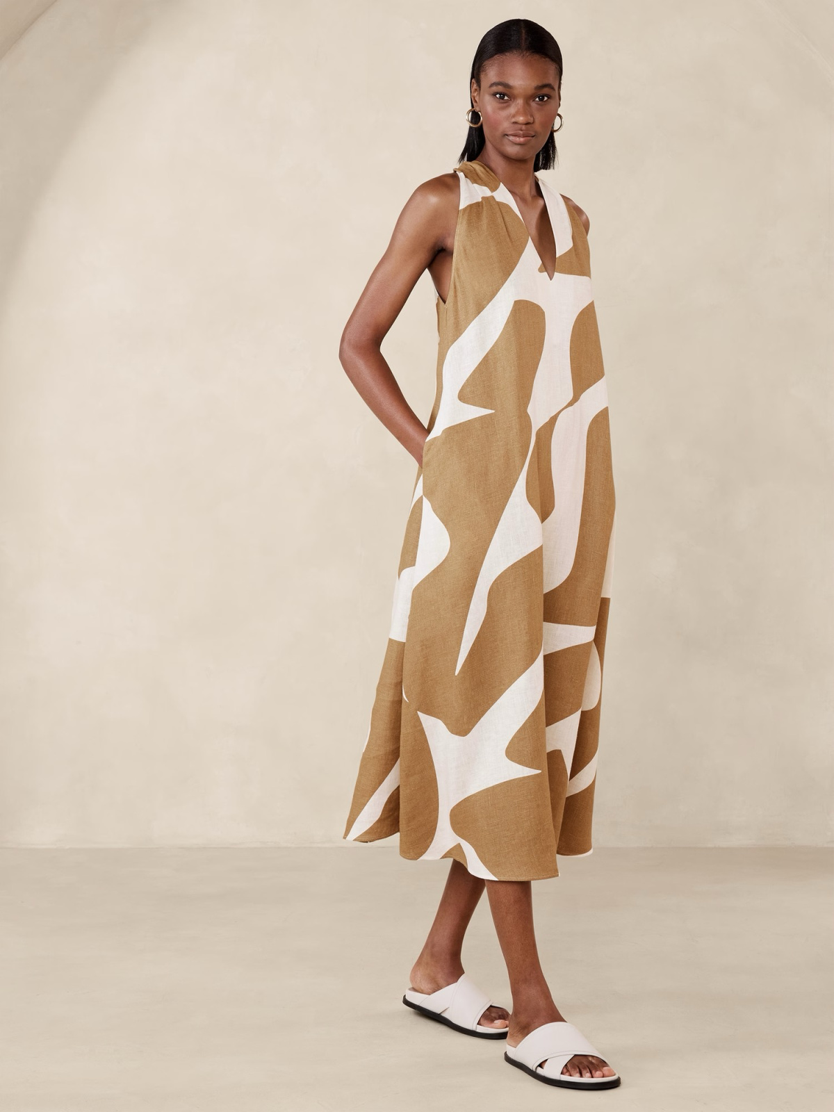 Model wearing Banana Republic giraffe print linen dress.