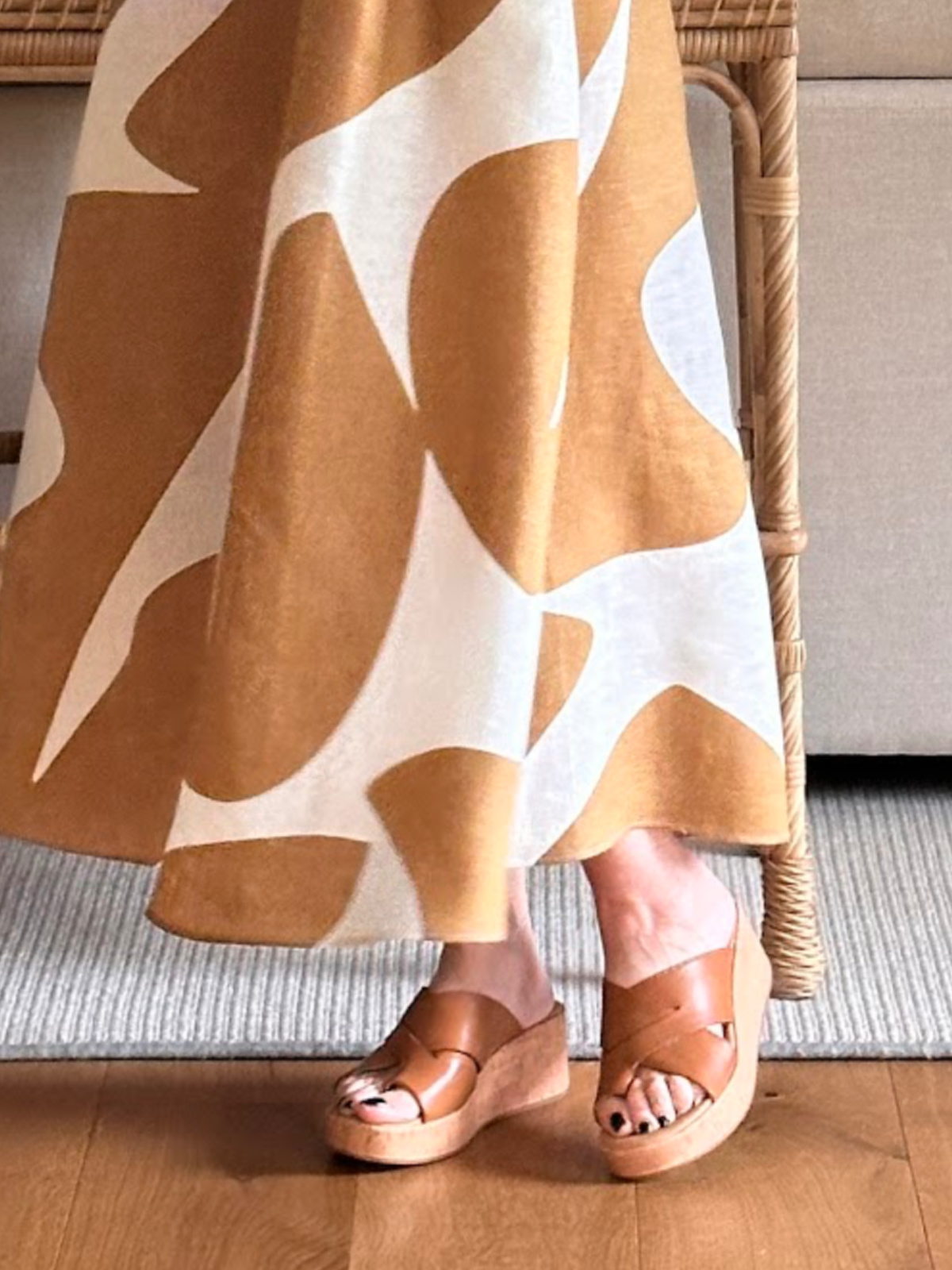 Close up of woman wearing Born wedge summer sandals.