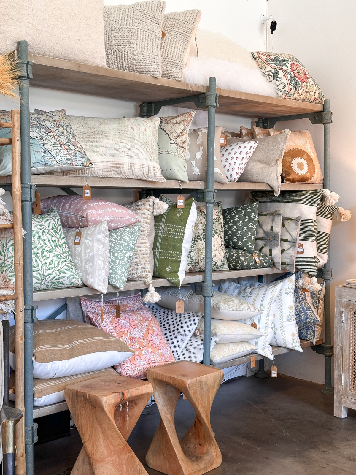 Shelves of decorative pillows at Rust in The Barlow.