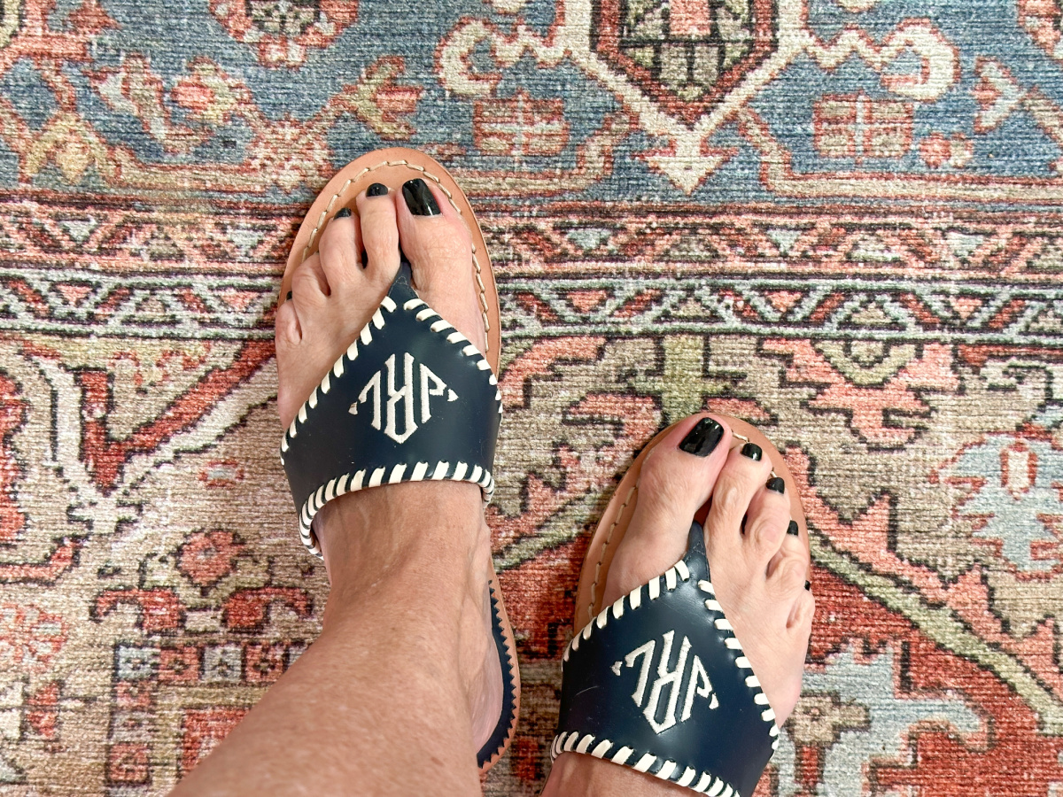 Close up of Jack Rogers monogrammed sandals.