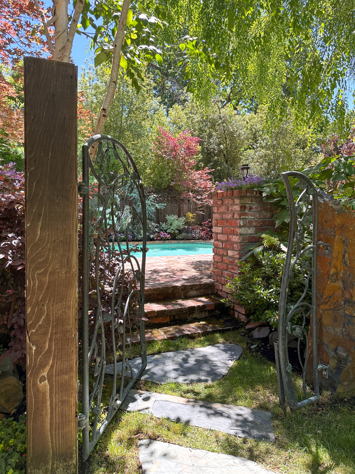 Charming iron gate leading to pool.
