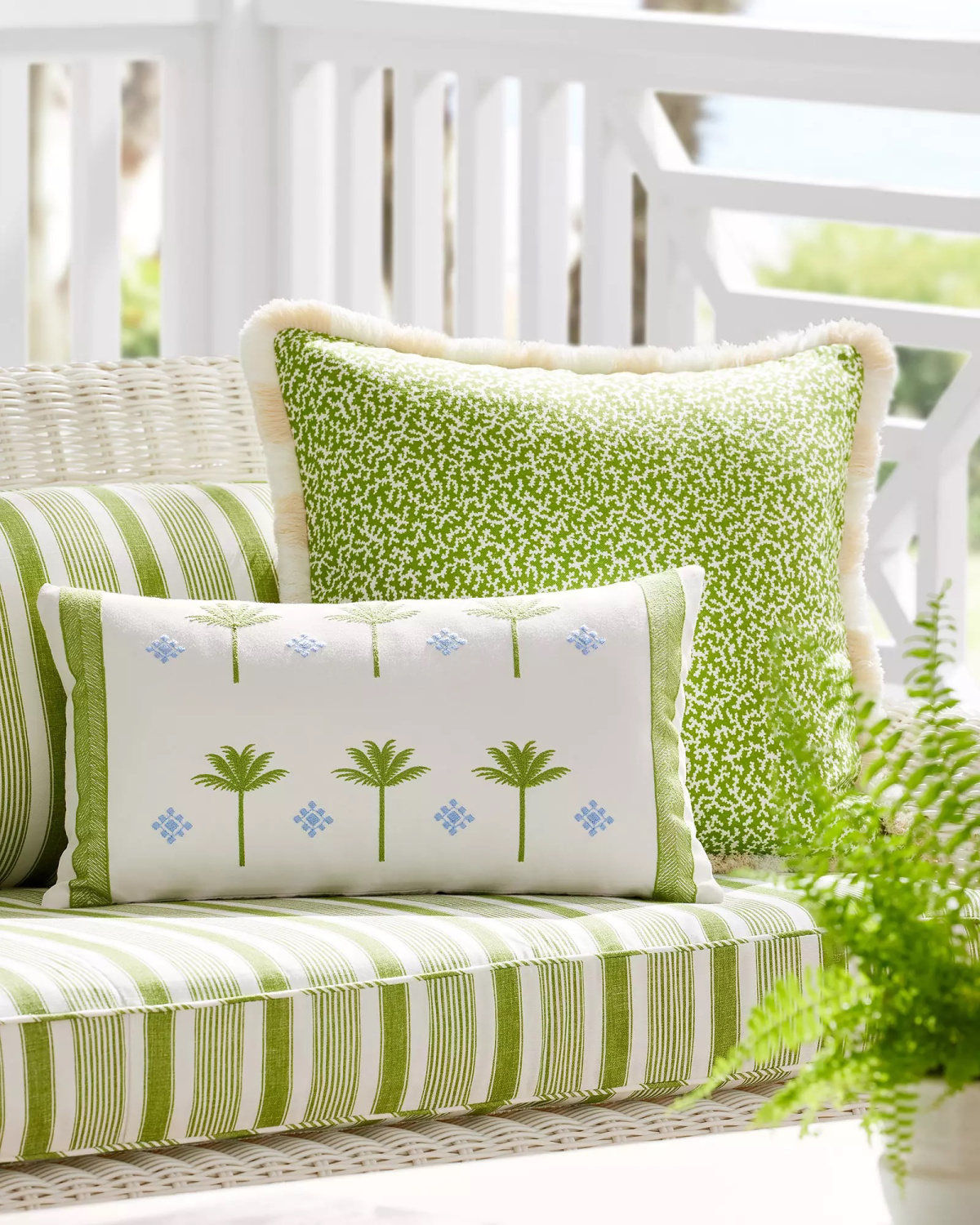 Serena & Lily green and white outdoor cushions and pillows.